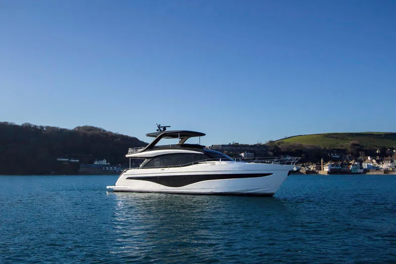 Slide: The Image of 2025 Princess Y72 Motor Yacht on serene water with scenic background. - 4