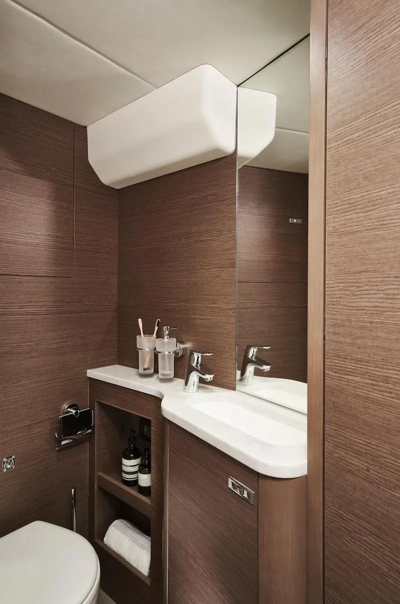 Slide: The Image of Luxurious bathroom in 2025 Princess Y72 Motor Yacht with modern fixtures and wood paneling. - 40