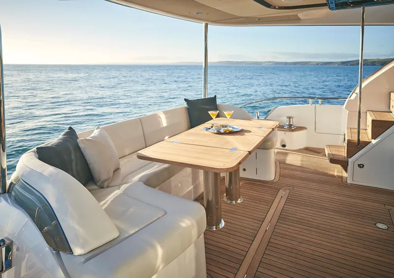 Slide: The Image of Luxurious 2025 Princess Y72 Motor Yacht deck with ocean view and elegant seating. - 9