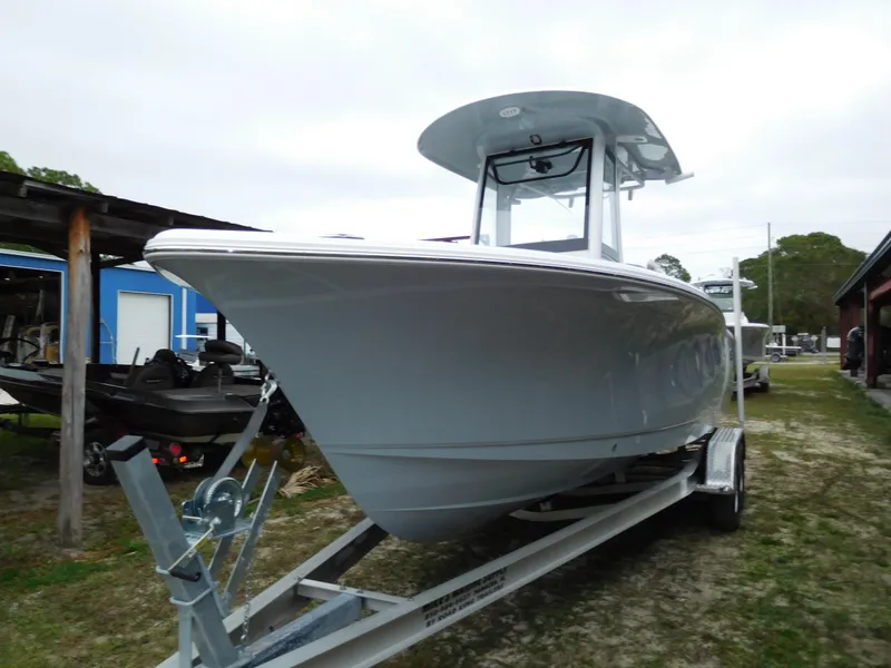 Slide: The Image of 2025 Sea Hunt Ultra 239 SE boat on trailer, parked outdoors. - 1