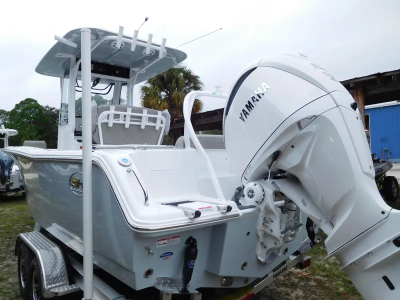 Slide: The Image of 2025 Sea Hunt Ultra 239 SE boat with Yamaha engine, parked on a trailer. - 2