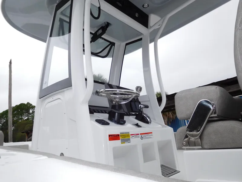Slide: The Image of 2025 Sea Hunt Ultra 239 SE boat console with steering wheel and seating. - 4