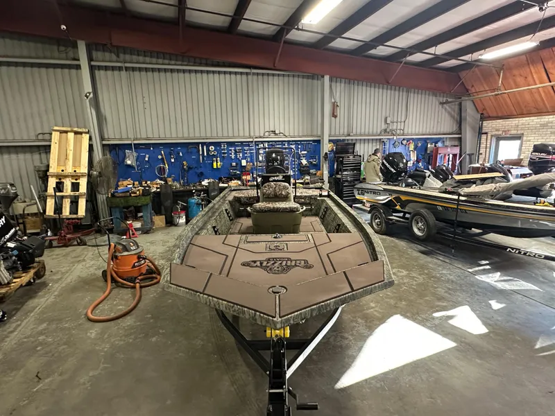 Slide: The Image of 2025 Tracker Grizzly 1860 CC boat in a workshop setting. - 4