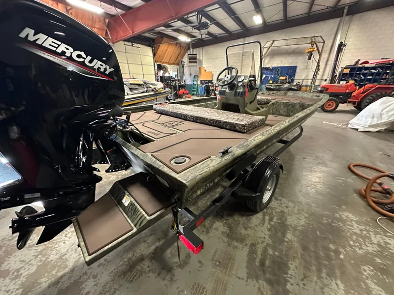 Slide: The Image of 2025 Tracker Grizzly 1860 CC boat with Mercury engine in a workshop. - 6