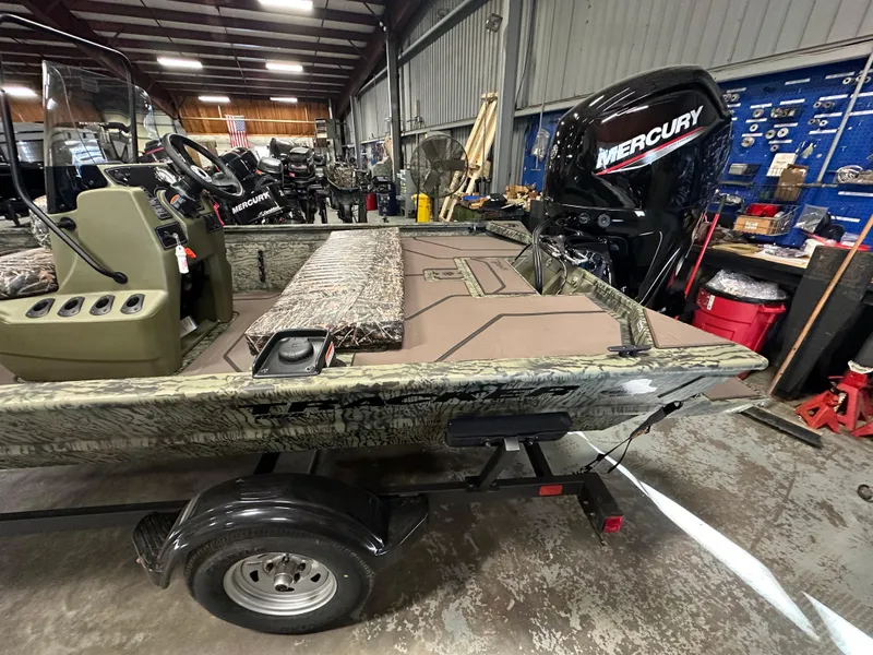 Slide: The Image of 2025 Tracker Grizzly 1860 CC boat in workshop with Mercury outboard motor. - 7