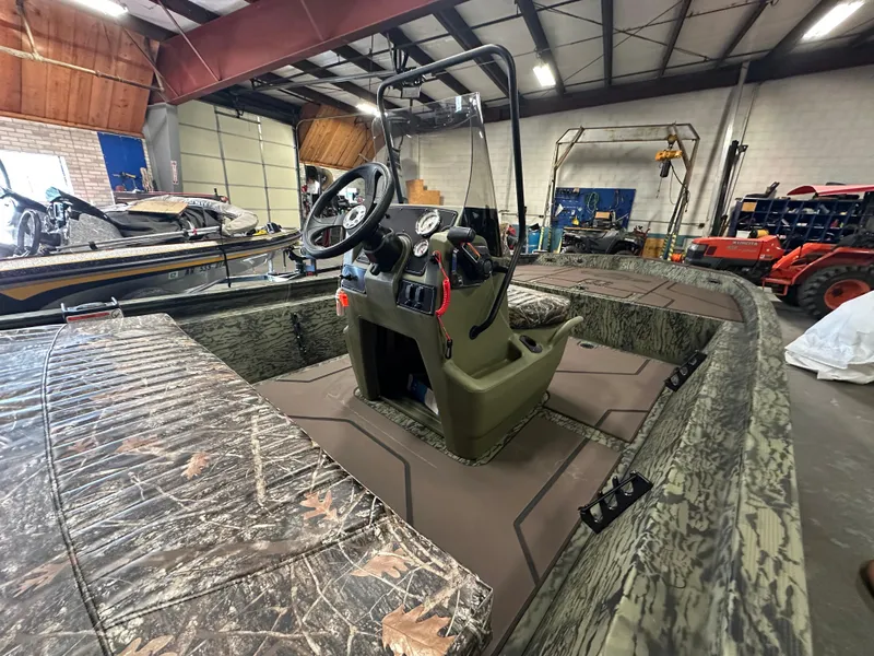 Slide: The Image of 2025 Tracker Grizzly 1860 CC boat interior in a workshop setting. - 8