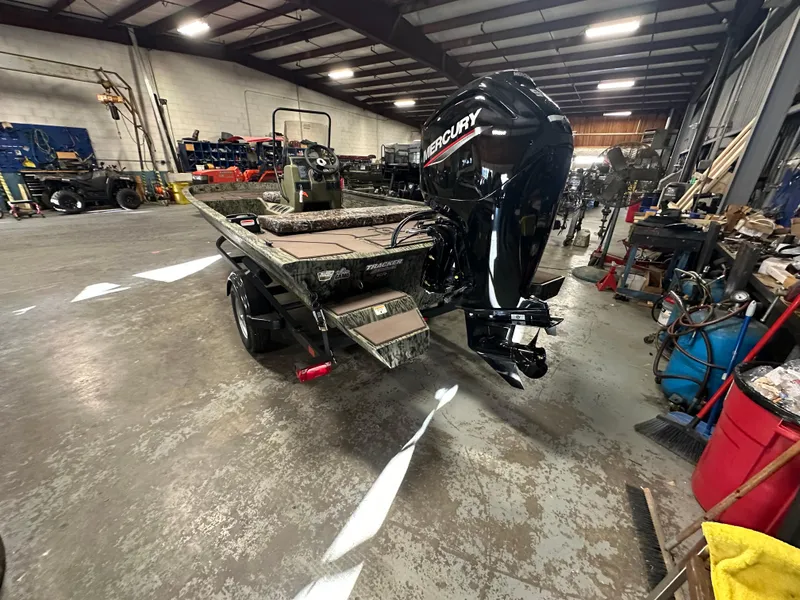 Slide: The Image of 2025 Tracker Grizzly 1860 CC boat with Mercury engine in a workshop. - 9