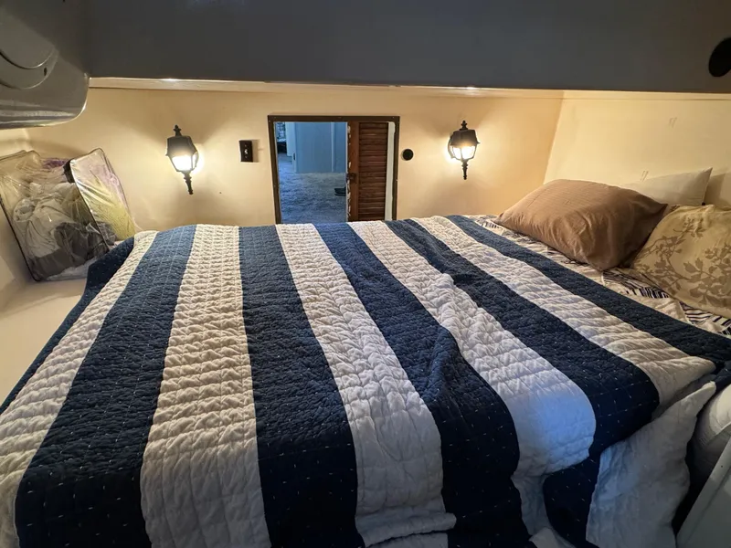 Slide: The Image of Cozy 1979 Nauta-Line Nautaline cabin interior with striped bedding and wall lamps. - 15