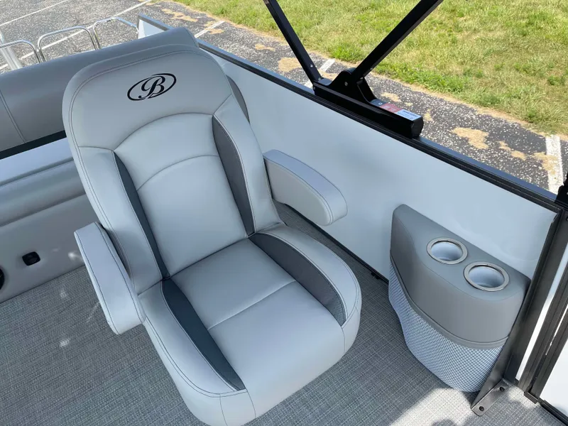 Slide: The Image of 2025 Bentley Pontoons Legacy 243 Swingback interior with gray seating and cup holders. - 15