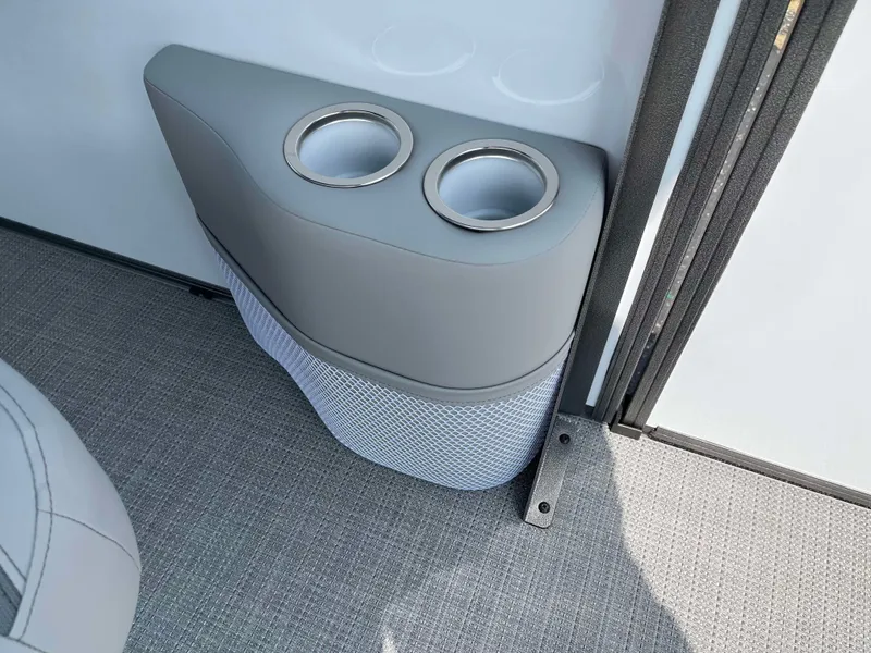 Slide: The Image of 2025 Bentley Pontoons Legacy 243 Swingback cup holders and storage compartment. - 16