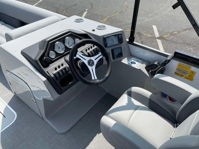 Slide: The Image of 2025 Bentley Pontoons Legacy 243 Swingback dashboard with steering wheel and controls. - 18