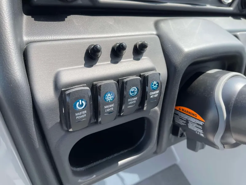 Slide: The Image of Control panel of 2025 Bentley Pontoons Legacy 243 Swingback with power and lighting switches. - 21
