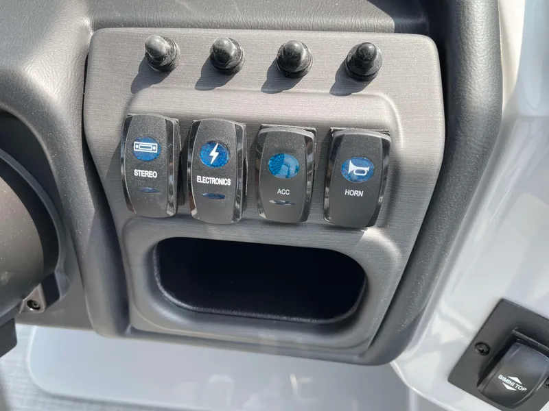 Slide: The Image of Control panel of 2025 Bentley Pontoons Legacy 243 Swingback with labeled switches. - 22