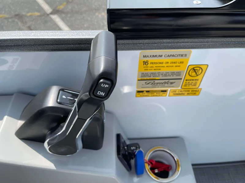 Slide: The Image of 2025 Bentley Pontoons Legacy 243 Swingback control panel with capacity label and throttle lever. - 24