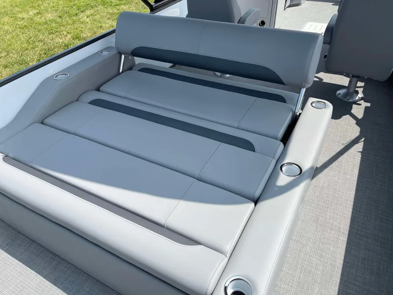 Slide: The Image of 2025 Bentley Pontoons Legacy 243 Swingback interior seating with gray upholstery and cup holders. - 26