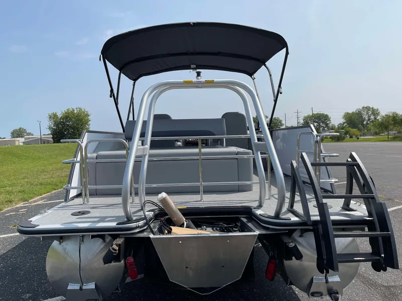 Slide: The Image of 2025 Bentley Pontoons Legacy 243 Swingback, rear view with canopy and seating. - 3