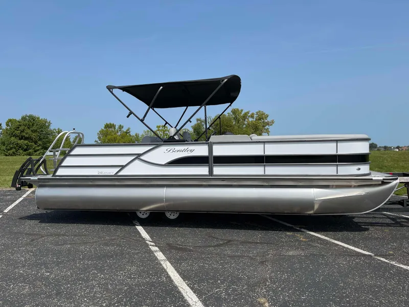 Slide: The Image of 2025 Bentley Pontoons Legacy 243 Swingback pontoon boat with canopy in parking lot. - 5