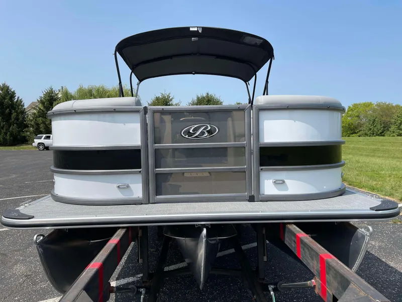 Slide: The Image of 2025 Bentley Pontoons Legacy 243 Swingback on trailer, parked outdoors. - 7