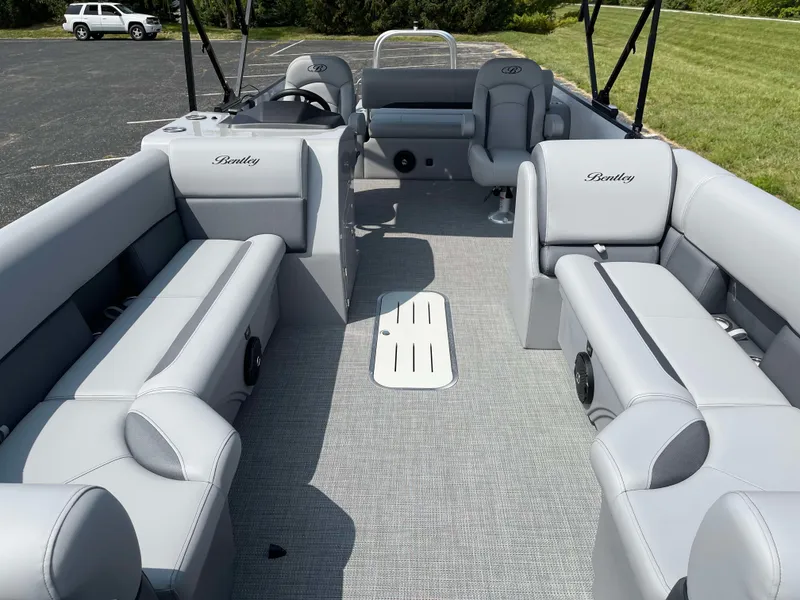 Slide: The Image of 2025 Bentley Pontoons Legacy 243 Swingback interior with gray seating and spacious layout. - 8