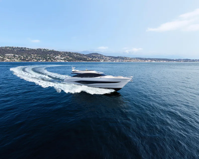 Slide: The Image of 2025 Princess S80 yacht cruising on open sea, scenic coastal backdrop. - 5
