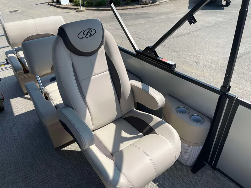 Slide: The Image of 2025 Bentley Pontoons Legacy 223 QSB captain's chair with cup holders, luxurious design. - 13