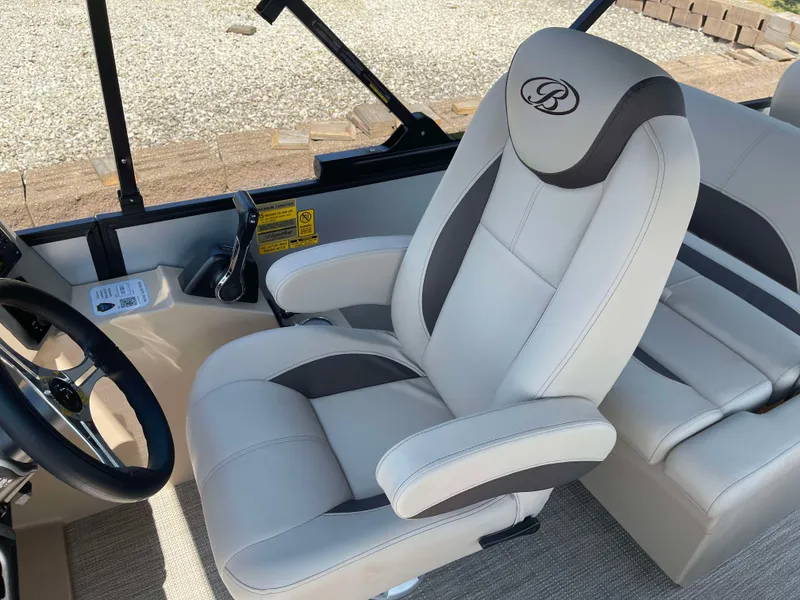Slide: The Image of 2025 Bentley Pontoons Legacy 223 QSB interior, featuring luxurious captain's chair and steering console. - 14