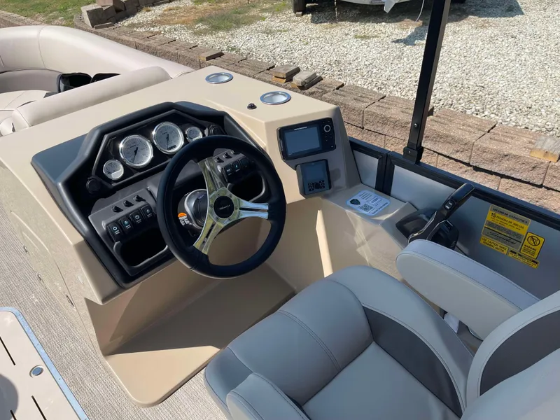 Slide: The Image of 2025 Bentley Pontoons Legacy 223 QSB dashboard with steering wheel and controls. - 15