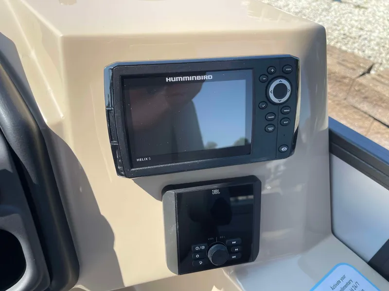 Slide: The Image of 2025 Bentley Pontoons Legacy 223 QSB dashboard with Humminbird and JBL controls. - 19