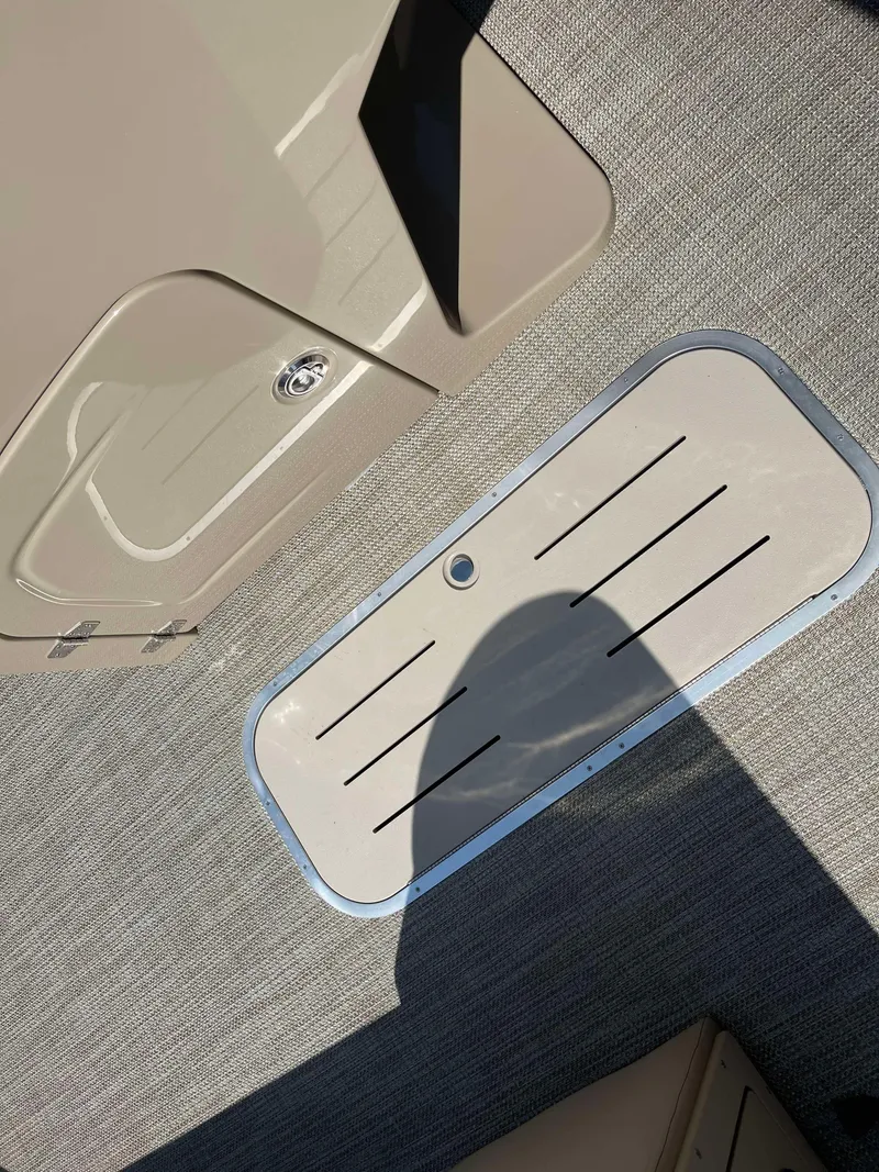 Slide: The Image of 2025 Bentley Pontoons Legacy 223 QSB deck detail with storage compartment. - 9