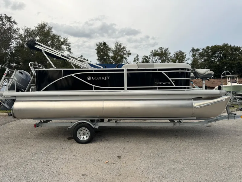 The Image of 2025 Sweetwater 2086 BF pontoon boat on trailer, parked outdoors. - 0