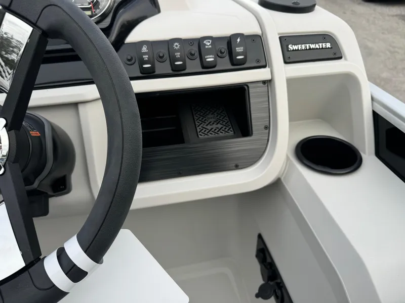 Slide: The Image of Sweetwater 2086 BF 2025 boat dashboard with steering wheel and control panel. - 7