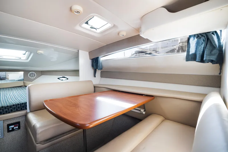 Slide: The Image of Interior of 2005 Bayliner 285 boat with dining area and seating. - 14