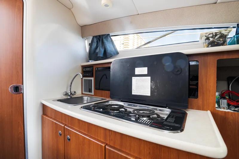 Slide: The Image of 2005 Bayliner 285 boat interior kitchen with stove and sink. - 17