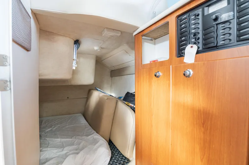 Slide: The Image of Interior cabin of 2005 Bayliner 285 boat with cozy sleeping area and wooden cabinetry. - 19