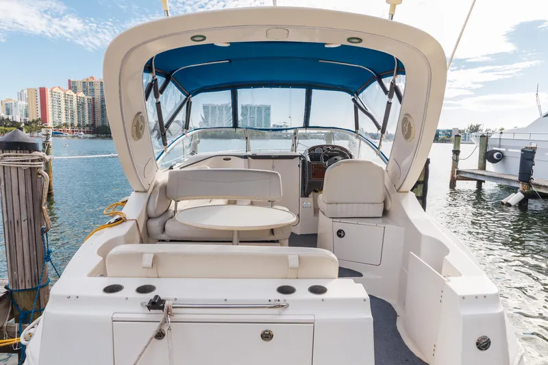 Slide: The Image of 2005 Bayliner 285 boat interior with blue canopy, docked in marina. - 5