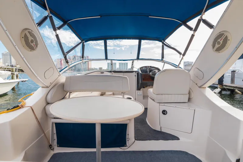 Slide: The Image of Interior view of 2005 Bayliner 285 boat with blue canopy and seating area. - 7