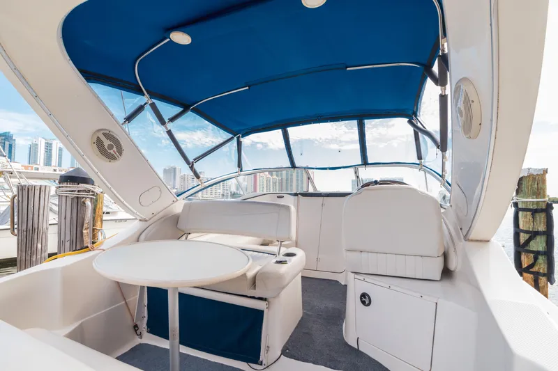 Slide: The Image of 2005 Bayliner 285 boat interior with blue canopy and seating area. - 9