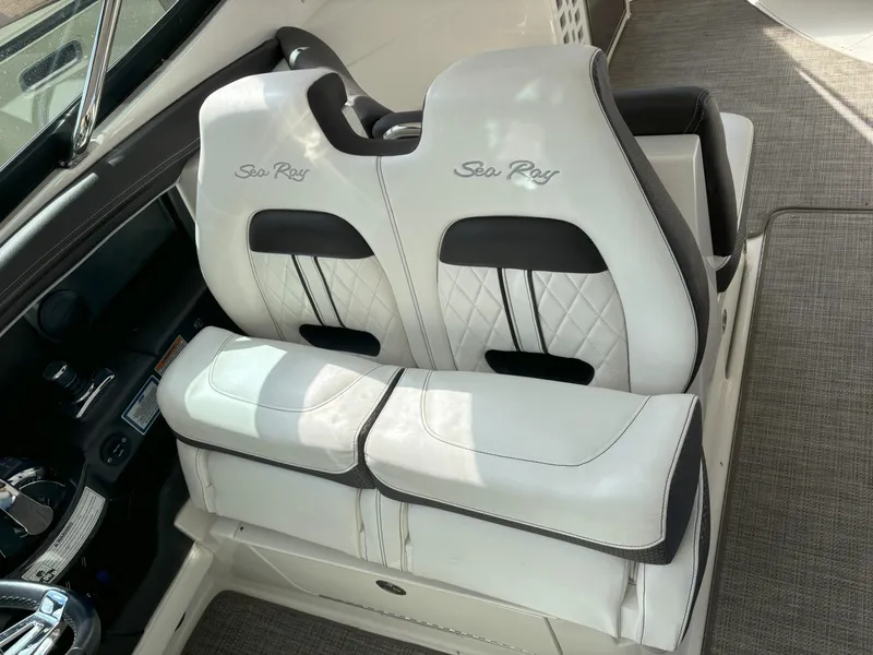 Slide: The Image of 2016 Sea Ray 350 SLX boat interior with white leather seats and embroidered logo. - 11