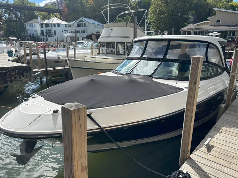 Slide: The Image of 2016 Sea Ray 350 SLX boat docked at marina, covered and ready for use. - 13