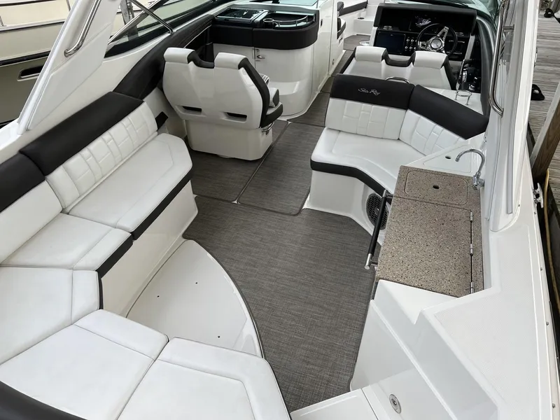 Slide: The Image of 2016 Sea Ray 350 SLX boat interior with white seating and modern helm. - 18