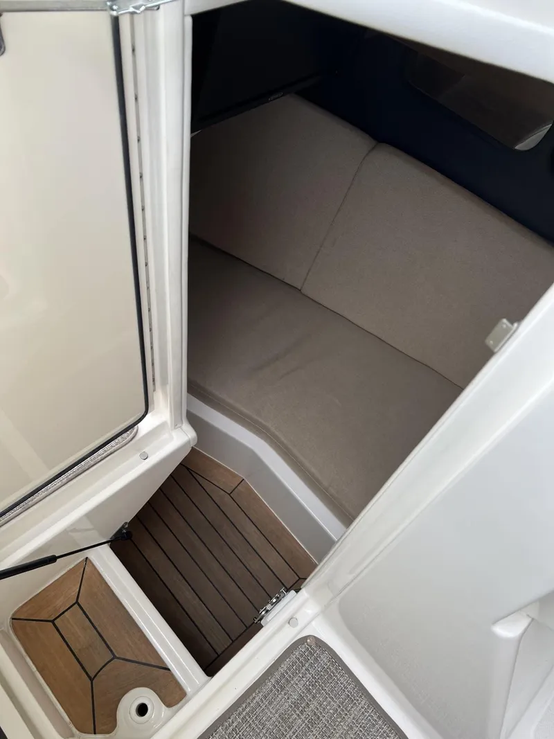 Slide: The Image of Interior cabin of 2016 Sea Ray 350 SLX with beige seating and wooden flooring. - 19