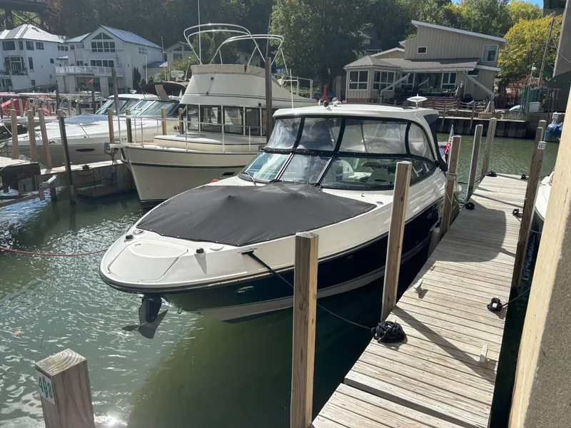 Slide: The Image of 2016 Sea Ray 350 SLX docked at a marina with covered bow. - 21