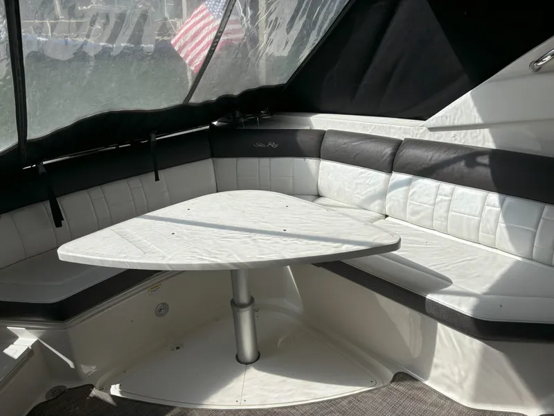 Slide: The Image of Interior seating area of 2016 Sea Ray 350 SLX boat with table. - 23