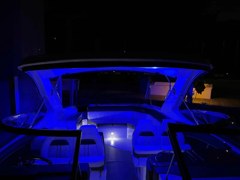 Slide: The Image of 2016 Sea Ray 350 SLX boat illuminated with blue LED lights at night. - 28