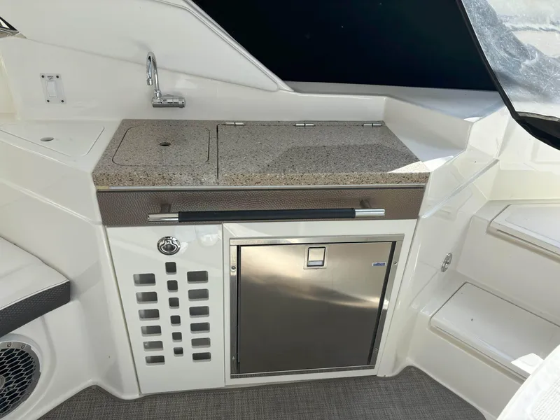 Slide: The Image of 2016 Sea Ray 350 SLX boat kitchenette with sink and mini fridge. - 7
