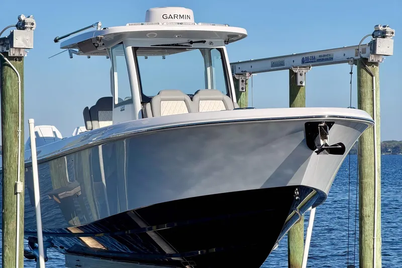 The Image of 2025 Everglades 315 Center Console boat docked, featuring sleek design and Garmin equipment. - 0