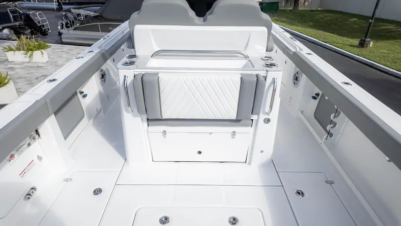 Slide: The Image of 2025 Everglades 315 Center Console boat interior with sleek white seating and storage. - 10