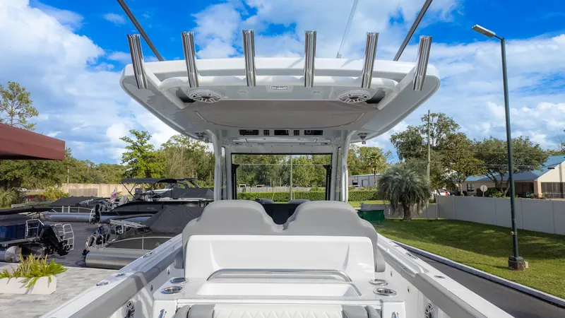 Slide: The Image of 2025 Everglades 315 Center Console boat, sleek design, outdoor setting, blue sky. - 11