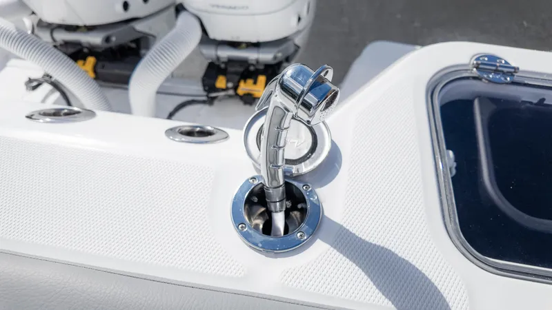 Slide: The Image of 2025 Everglades 315 Center Console boat detail with chrome fittings and engine components. - 17