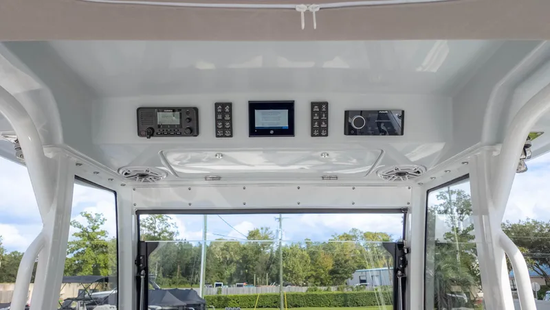 Slide: The Image of 2025 Everglades 315 Center Console boat interior with modern control panel and navigation equipment. - 22
